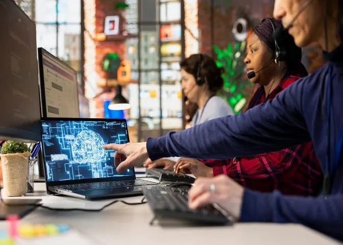 Colleagues learning to use artificial intelligence tools on computers